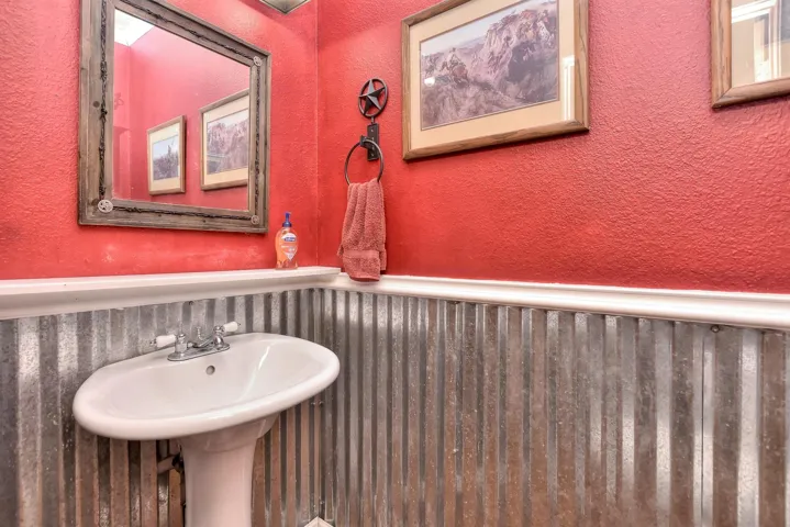 Bathroom featuring a wainscoted wall and a textured wall