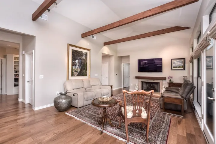 Living room featuring wood finished floors, and a fireplace