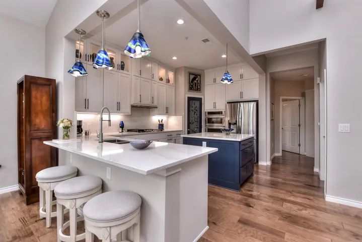 Kitchen with a kitchen island, stainless steel appliances, and wood finished floors