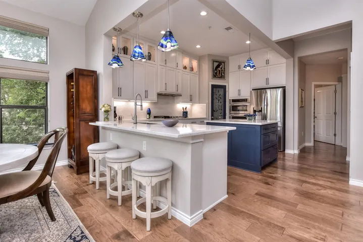 Kitchen with a kitchen bar, a center island, and stainless-steel appliances