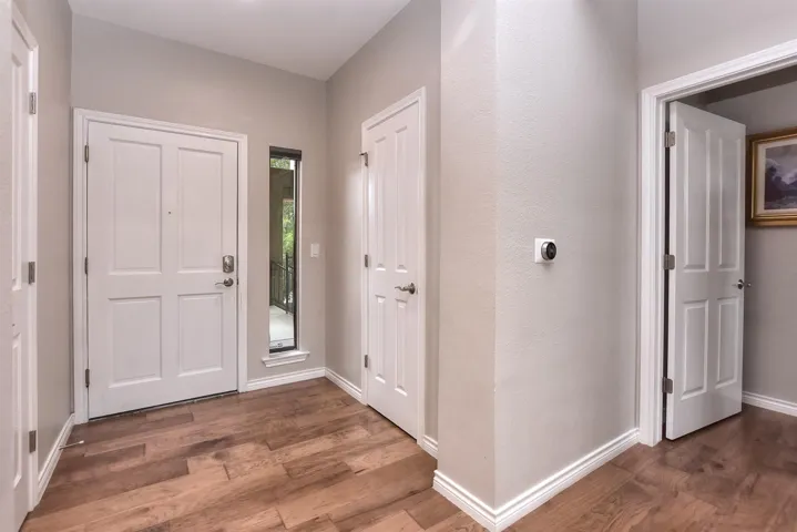 Foyer entrance featuring baseboards and wood finished floors