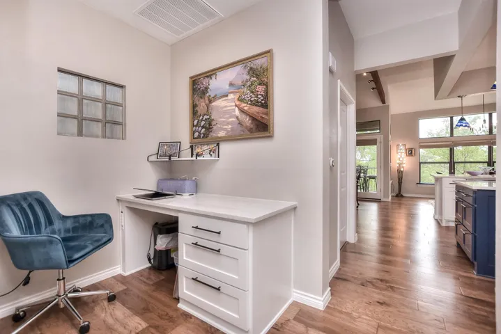 Office area built in desk, and wood finished floors
