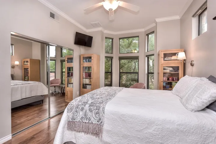 Bedroom featuring great windows and California custom closet