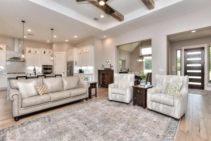 Living room featuring light wood-type flooring, ceiling fan, and recessed lighting