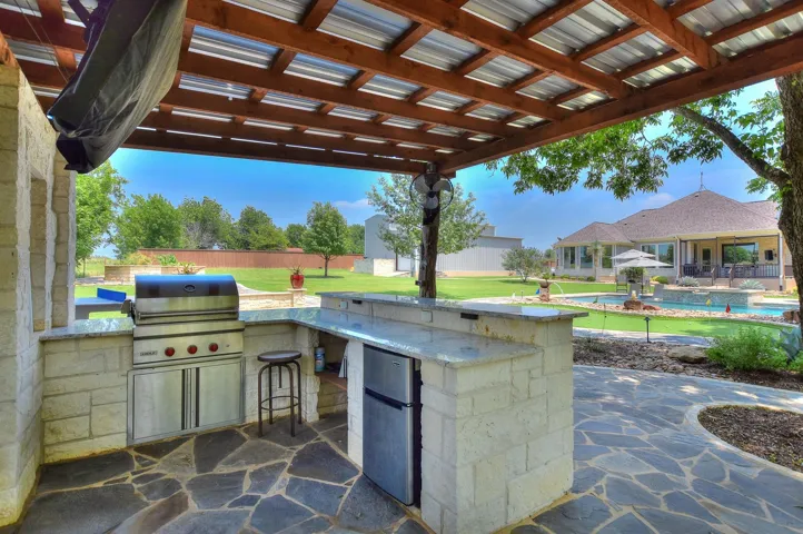 View of patio / terrace with area for grilling and a grill