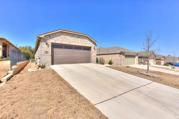 Ranch-style home with brick siding, driveway, and a garage