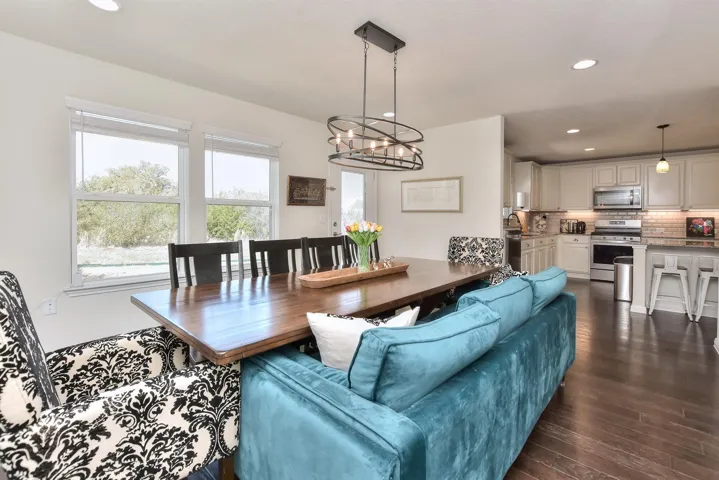 Living room featuring a chandelier, dark wood-style flooring, and recessed lighting