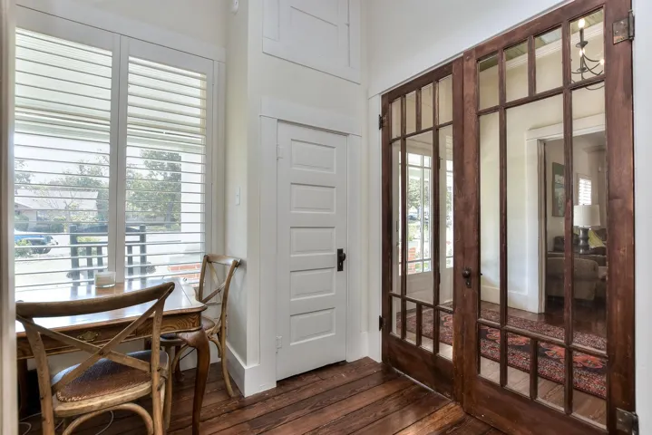Entrance foyer with dark wood-style floors, healthy amount of natural light, and french doors