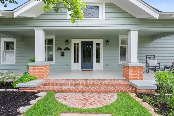 View of exterior entry featuring covered porch