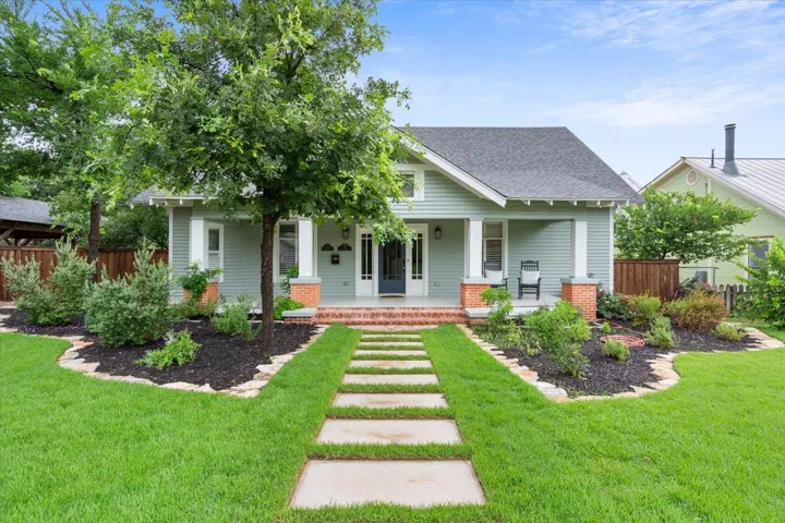 View of front of house with roof with shingles and covered porch