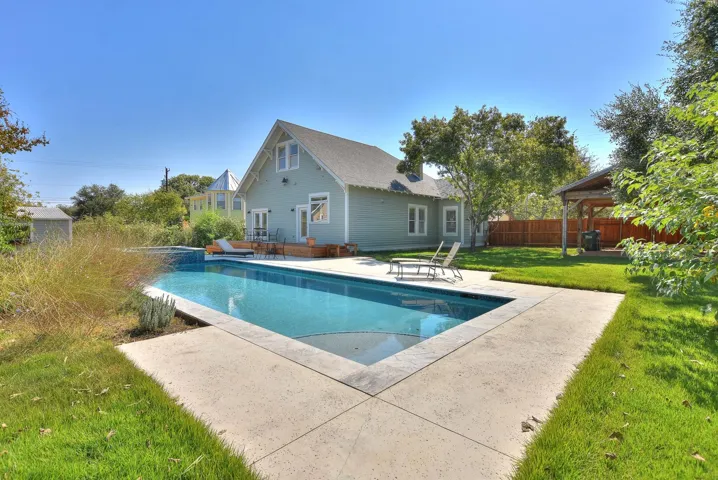 View of swimming pool with a patio and a pool with connected hot tub