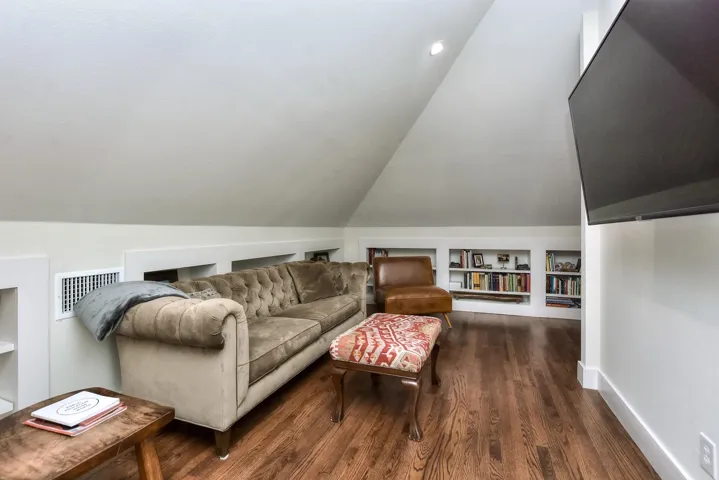 Living room featuring wood finished floors and lofted ceiling