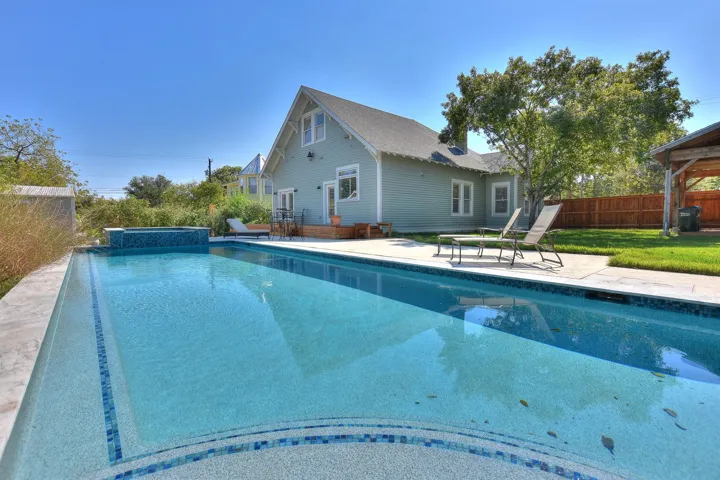 View of swimming pool featuring a patio and a pool with connected hot tub