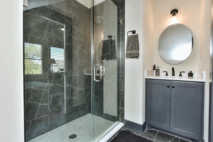 Bathroom featuring a shower stall and vanity