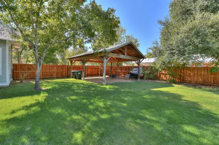 Fenced backyard with a gazebo