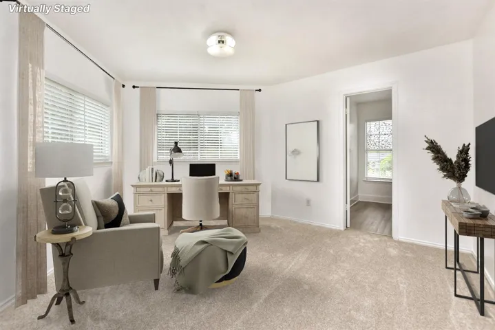 This is such a great space.... you can truly outfit this primary suite in such a way that you would never have to leave it! The primary bathroom sits just beyond this space.  Virtually Staged.