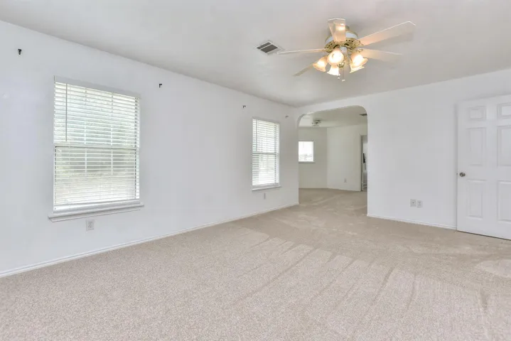 The primary suite has fresh carpet and here you can see that additional sitting room that could be used for a home office, hobby room, reading room, home gym, nursury....whatever your heart desires!