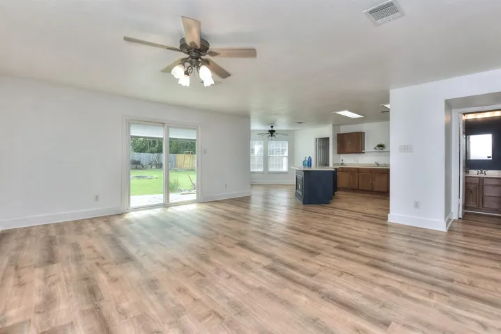Another example of just how open this home's living spaces are....here is also a convenient powder room to the right. 