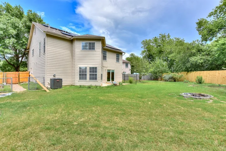 Side yard already has an established garden area with beds and there is already a built-in fire pit!
