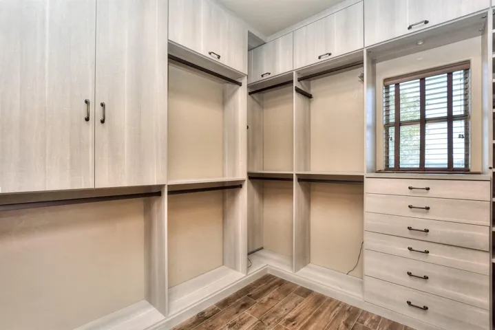 Primary bedroom has a California designed closet w/built in drawers, shoe shelving and cabinets