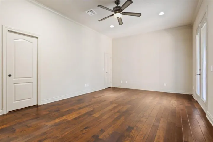 Unfurnished room with dark wood finished floors, ornamental molding, a ceiling fan, and recessed lighting