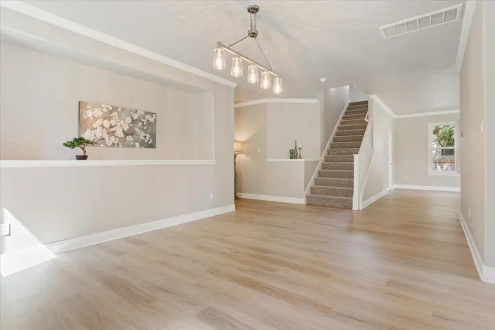 Living room featuring light wood-style flooring, and stairway