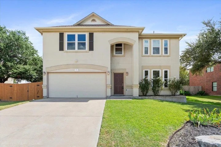 View of front of house featuring an attached garage, stucco siding, and concrete driveway