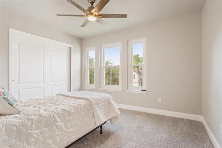 Bedroom with ceiling fan, and a closet