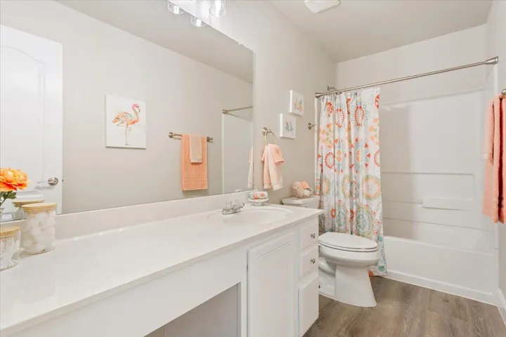 Bathroom featuring vanity, shower / bath combination