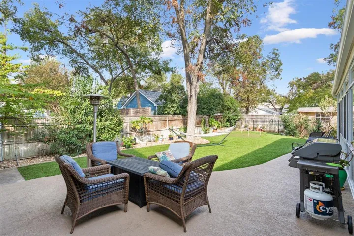 AND there is an uncovered patio outside the glassed in patio.  Notice there is "astro turf" in the backyard.  Simply blow the leaves off when they fall!