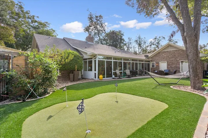THIS is your backyard!  Your own putting area surrounded completely by "astro turf grass".  Simply blow the leaves off when they fall.  This backyard also has a dog run and a fenced in garden area!  SCORE!