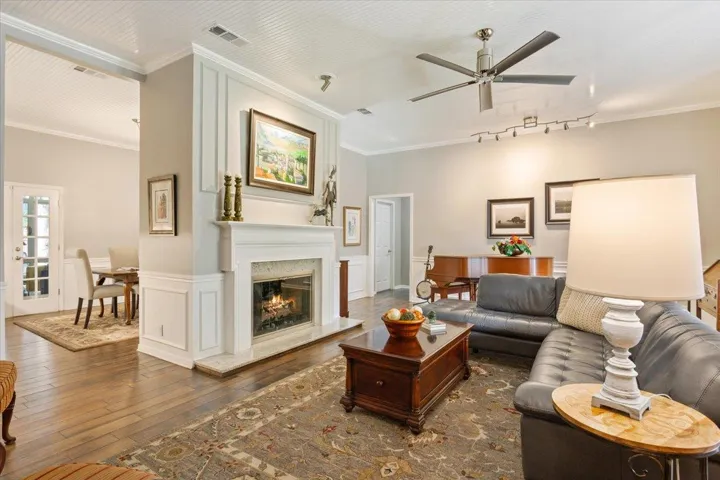 The fireplace is the center of the Great Room and could not be more stately featuring great trim work & a gas lighter...