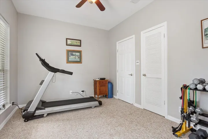2nd bedroom is currently used for an exercise room, but is truly a bedroom with a closet, ceiling fan, and windows...