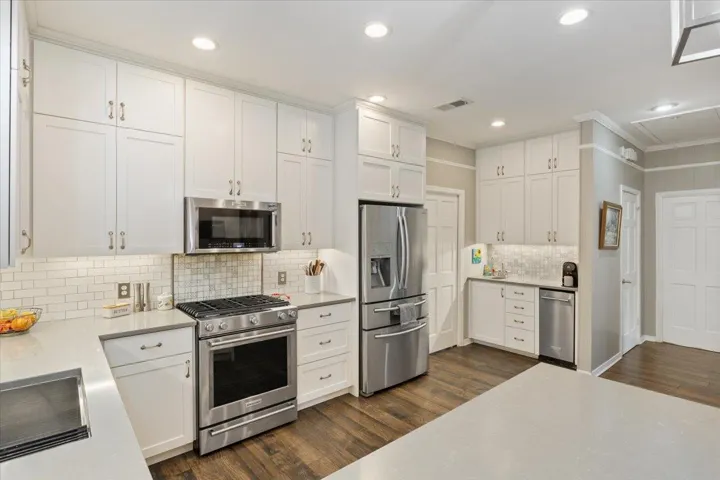 The kitchen was completely remodeled in 2020 with new cabinets, new flooring, a stainless 5 burner Kitchen Aid gas stove, microwave, recessed lighting plus pendant lights, a stainless farm sink & goodneck faucet.  