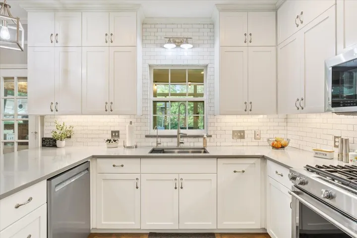 I love a window over the kitchen sink!  Watch what's happening in the backyard & serve through this window to the amazing enclosed patio....