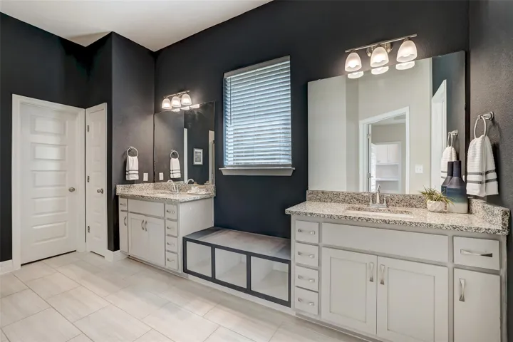 Navy Blue Accent Wall highlights the split vanities