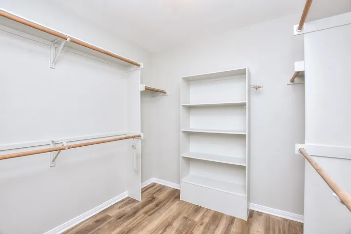 Walk in closet featuring light wood-type flooring