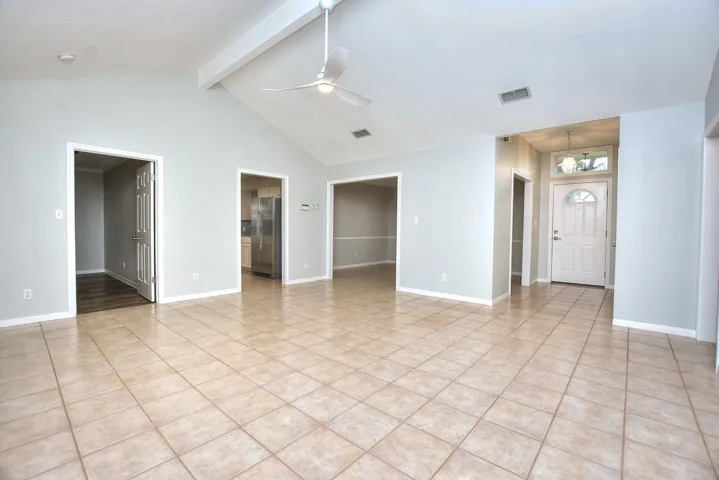 living room featuring ceiling fan and light tile patterned flooring