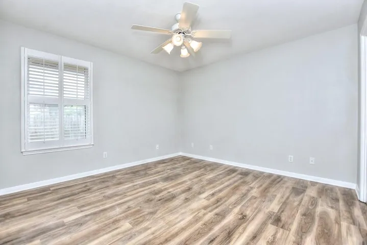 Bedroom with light wood-type flooring and a ceiling fan