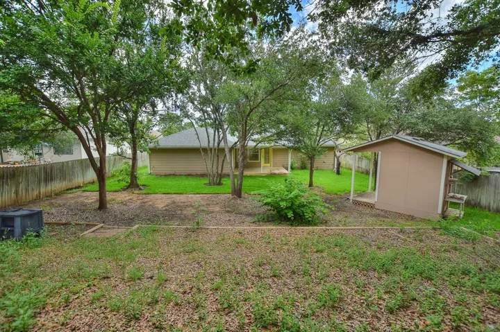 Fenced backyard with a shed