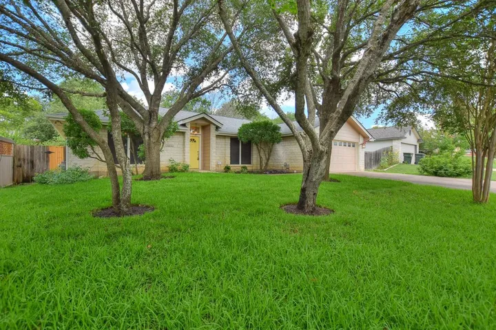 Ranch-style house with driveway and a garage
