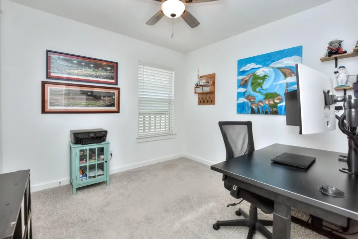 Office featuring baseboards, a ceiling fan, and carpet