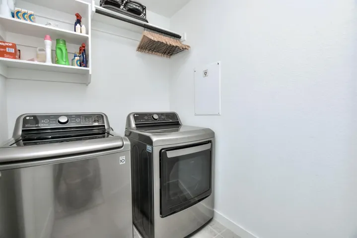 Laundry area with baseboards, independent washer and dryer, and laundry area