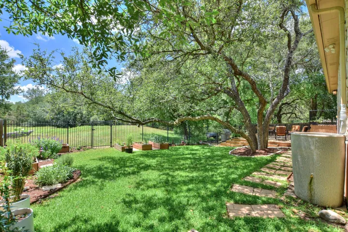 The backyard is fully fenced with wrought iron fencing.  There is a gate to access the back yard from both sides of the home....