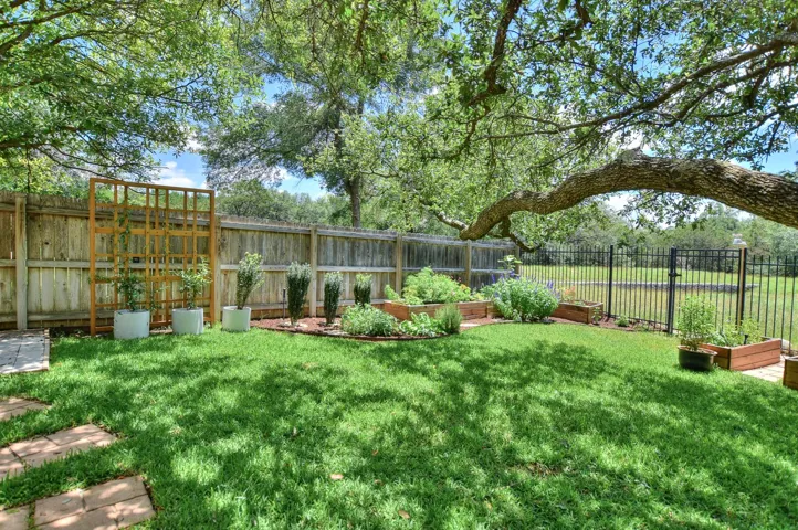 Another view of your backyard gardens.  On the left, you get a glimpse of a slab poured for a storage building if you want one.  Brick walkway leads to the side of the house.