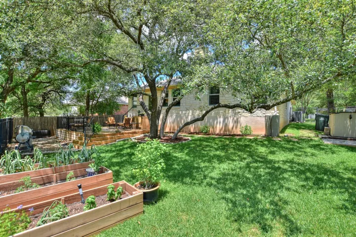 In addition to the decks, you have raised beds to grow vegetables, flowers or whatever you like to add to the lush garden area...