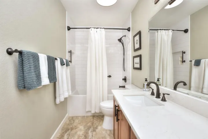 This is the updated bathroom in between the 2 secondary bedrooms. White Subway tile was added as was a 21" deep bathtub/shower combo.  The linen closet is behind the entry door to this bathroom.