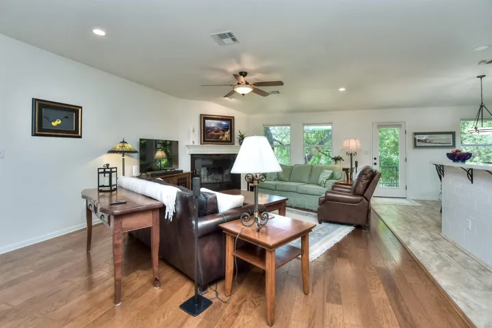 You will enjoy the views from this family room. Windows & glass insert door show off the greenbelt...