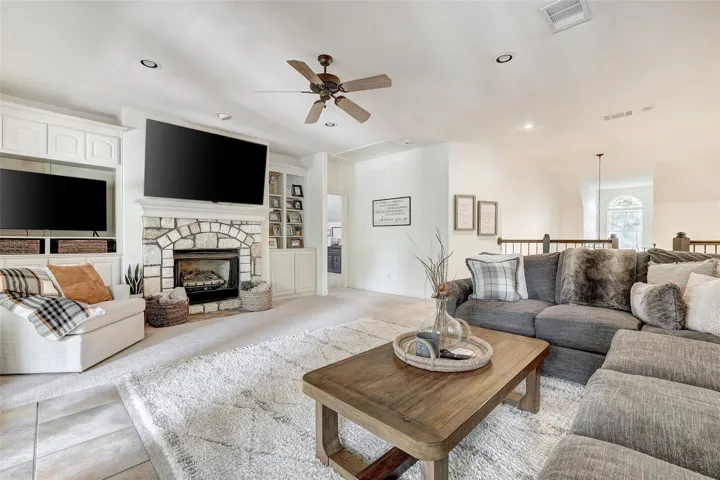 Upstairs living room or flex space with stone fireplace