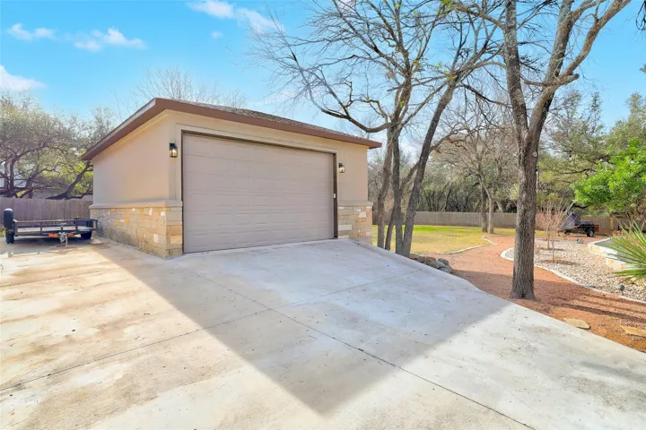 Garage featuring concrete driveway
